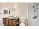 Cozy bathroom with granite countertop, wood cabinetry, bright lighting and a shower-tub combo at 2985 Blue Sky Cir # 7-107, Erie, CO 80516