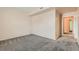 A room with soft carpeting and neutral paint leading to other areas of the house at 2985 Blue Sky Cir # 7-107, Erie, CO 80516