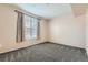 Bedroom with a large window with curtains for natural light and neutral walls at 2985 Blue Sky Cir # 7-107, Erie, CO 80516