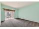 Bright bedroom featuring a sliding glass door for natural light and gray carpeting at 2985 Blue Sky Cir # 7-107, Erie, CO 80516