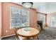 Bright dining area with a round table with chairs, offering a great view from the window, next to the fireplace at 2985 Blue Sky Cir # 7-107, Erie, CO 80516