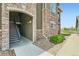 Exterior view of condo featuring brick accents and staircase leading to unit 7 with well maintained landscaping at 2985 Blue Sky Cir # 7-107, Erie, CO 80516