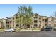 Inviting condo building with well-maintained landscaping and multiple balconies under a clear blue sky at 2985 Blue Sky Cir # 7-107, Erie, CO 80516