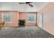Inviting living room with neutral walls, carpet, natural light, and a cozy fireplace adjacent to the dining area at 2985 Blue Sky Cir # 7-107, Erie, CO 80516