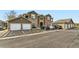 Convenient parking area with multiple spaces in front of condo units with garage doors and stone accents at 2985 Blue Sky Cir # 7-107, Erie, CO 80516