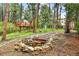 Expansive backyard with a scenic pond, mature trees and a playhouse and slide at 19070 White Fawn Dr, Monument, CO 80132