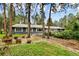 Expansive backyard with mature trees, landscaping, and a serene outdoor setting at 19070 White Fawn Dr, Monument, CO 80132