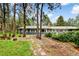 Lovely backyard with a stone path, a charming fence, and mature trees adding to the natural beauty at 19070 White Fawn Dr, Monument, CO 80132