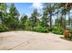 Large concrete backyard patio with trees and a wooden fence. Perfect for entertaining at 19070 White Fawn Dr, Monument, CO 80132