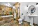 Bathroom with soaking tub and patterned tiling throughout at 19070 White Fawn Dr, Monument, CO 80132