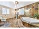 Bathroom with patterned tiles and a soaking tub at 19070 White Fawn Dr, Monument, CO 80132