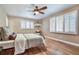 Bedroom with hardwood floors, ceiling fan, shutters and a neutral color palette at 19070 White Fawn Dr, Monument, CO 80132