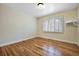 Neutral bedroom features hardwood floors, shuttered window and a wall shelf at 19070 White Fawn Dr, Monument, CO 80132