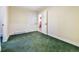 Bedroom with green carpet and a view into the bathroom at 19070 White Fawn Dr, Monument, CO 80132