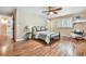 Bedroom with hardwood floors and a bed flanked by two nightstands with table lamps at 19070 White Fawn Dr, Monument, CO 80132