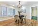 Charming dining area with hardwood floors, bright windows, and a stylish light fixture creating an inviting ambiance at 19070 White Fawn Dr, Monument, CO 80132