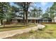 Charming home featuring blue siding, brick accents, a welcoming porch, and mature trees at 19070 White Fawn Dr, Monument, CO 80132