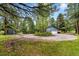 A charming blue house surrounded by trees with a circular driveway at 19070 White Fawn Dr, Monument, CO 80132