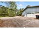 Exterior view of a blue home with a white garage door and a long driveway at 19070 White Fawn Dr, Monument, CO 80132