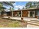 Inviting front porch with white columns, rocking chairs, brick accents, and a cheerful entry at 19070 White Fawn Dr, Monument, CO 80132
