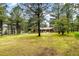 Beautiful single story home with brick accents and a large front yard surrounded by mature trees at 19070 White Fawn Dr, Monument, CO 80132