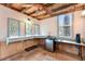 Interior of shed boasting tiled floors, multiple windows with leafy scenery, wooden beams and ample counter space at 19070 White Fawn Dr, Monument, CO 80132