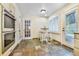Inviting breakfast nook with natural light from surrounding windows adjacent to the main kitchen at 19070 White Fawn Dr, Monument, CO 80132