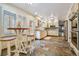 Charming kitchen with custom cabinets, stainless steel appliances, and a breakfast bar near bright windows at 19070 White Fawn Dr, Monument, CO 80132