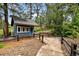 Exterior shot of a small blue shed nestled among mature trees, adding charm and practicality to the property at 19070 White Fawn Dr, Monument, CO 80132
