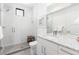 A bathroom with a glass shower, marble counter, and white cabinets at 4243 E 8Th Ave, Denver, CO 80220
