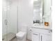 This bathroom features a glass shower, white cabinets and sink with granite countertops at 4243 E 8Th Ave, Denver, CO 80220