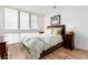 A primary bedroom featuring a large window and beautiful hardwood floors at 4243 E 8Th Ave, Denver, CO 80220
