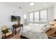 Bright bedroom with light wood floors, large window and access to the balcony at 4243 E 8Th Ave, Denver, CO 80220