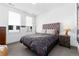 Bedroom featuring two windows, a tufted headboard, and hardwood floors at 4243 E 8Th Ave, Denver, CO 80220
