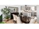 Open dining area features a dark wood table and chairs near kitchen at 4243 E 8Th Ave, Denver, CO 80220