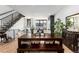 Bright dining room features a dark wood table with bench seating and staircase at 4243 E 8Th Ave, Denver, CO 80220