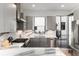 Modern kitchen featuring stainless appliances, custom cabinetry and a marble backsplash at 4243 E 8Th Ave, Denver, CO 80220