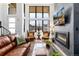 This elegant living room features a fireplace, soaring windows and beautiful hardwood floors at 4243 E 8Th Ave, Denver, CO 80220