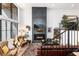 Elegant living room featuring a striking fireplace, high ceilings, and natural light at 4243 E 8Th Ave, Denver, CO 80220