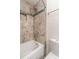 Bathroom showcasing a shower-tub combo with tiled walls and modern fixtures at 595 Manhattan Dr # 203, Boulder, CO 80303