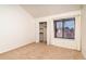 Bright bedroom with a large window, closet, and neutral carpeting at 595 Manhattan Dr # 203, Boulder, CO 80303