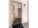 Open entryway reveals wood floors leading into carpeted living area and modern kitchen at 595 Manhattan Dr # 203, Boulder, CO 80303