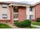 Charming exterior view with a brick staircase entrance and manicured landscaping at 595 Manhattan Dr # 203, Boulder, CO 80303