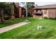 Inviting exterior showcasing the well-maintained lawn and charming architecture of the building at 595 Manhattan Dr # 203, Boulder, CO 80303