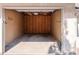 Spacious one-car garage interior showing concrete floor, wall studs, and open ceiling with lighting fixture at 595 Manhattan Dr # 203, Boulder, CO 80303