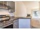 Stylish kitchen with granite countertops, stainless appliances, and an open view to the living room at 595 Manhattan Dr # 203, Boulder, CO 80303