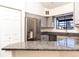 Modern kitchen features stainless steel appliances, granite countertops, and a large window at 595 Manhattan Dr # 203, Boulder, CO 80303