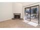 Inviting living area with fireplace and sliding doors leading to outdoor balcony at 595 Manhattan Dr # 203, Boulder, CO 80303