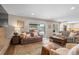 Cozy living room featuring comfortable sofas, area rug, and a sliding glass door to the backyard at 10703 W Turtle Mtn, Littleton, CO 80127