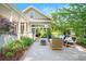 A stone patio with outdoor seating, perfect for enjoying the landscaped backyard at 3109 E Warren Ave, Denver, CO 80210